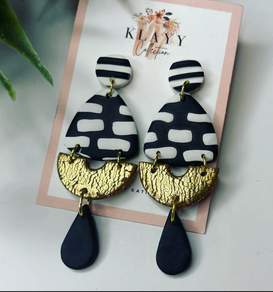 Black and White stripe polymer clay earrings with gold arch and dangles